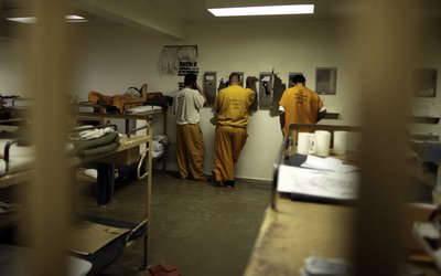 Inmates make phone calls from their cell at the Orange County jail in Santa Ana