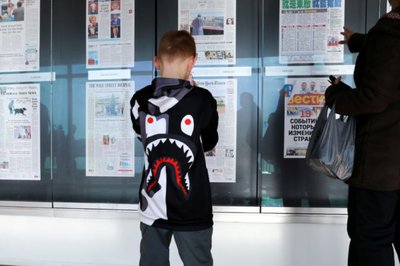 A child looks at a display of front pages as he visits the Newseum during its last week of operation before closing the museum in Washington