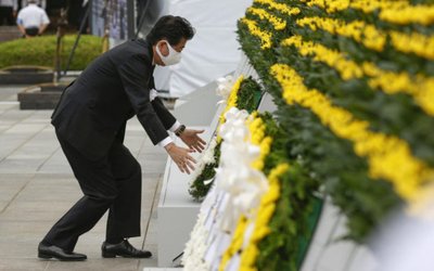 Japan's Prime Minister Shinzo Abe offers a wreath to the cenotaph for the victims of the 1945 atomic bombing, at Peace Memorial Park in Hiroshima, Japan