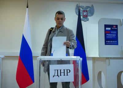 A man votes during a referendum on the joining of Russian-controlled regions of Ukraine to Russia, in Moscow