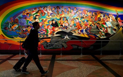 A man walks by the "Children of the World Dream Peace" mural at Denver International Airport outside Denver