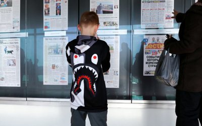 A child looks at a display of front pages as he visits the Newseum during its last week of operation before closing the museum in Washington