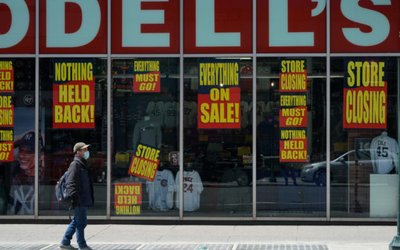 A man stands in front of a Modell's store that is closed, as retail sales suffer record drop during the outbreak of the coronavirus disease (COVID19) in New York