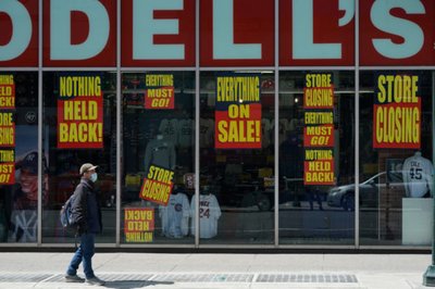 A man stands in front of a Modell's store that is closed, as retail sales suffer record drop during the outbreak of the coronavirus disease (COVID19) in New York
