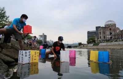 People release paper lanterns on the Motoyasu River facing the gutted Atomic Bomb Dome in remembrance of atomic bomb victims in Hiroshima, Japan