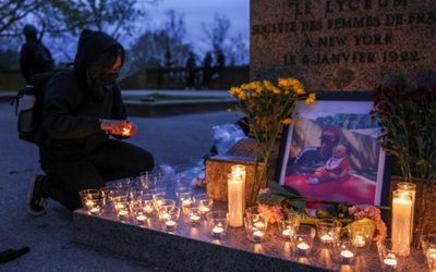 People take part in a vigil following the fatal police shooting of 20-year-old Black man Daunte Wright in Minnesota , in Washington