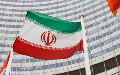 FILE PHOTO: The Iranian flag waves in front of the International Atomic Energy Agency (IAEA) headquarters, in Vienna