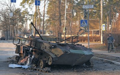 A charred armoured vehicle is seen on a street in Bucha