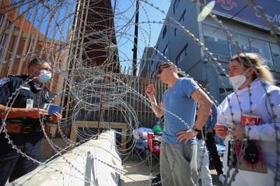 Russians wait for a humanitarian visas at the San Ysidro Port of Entry of the U.S.-Mexico border in Tijuana