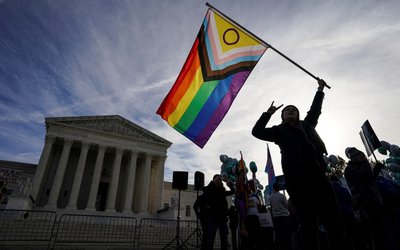 Activists gather outside U.S. Supreme Court as justices hear arguments in case involving LGBT rights in Washington