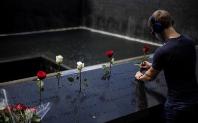 A man places roses at the 9/11 Memorial ahead of the 20th anniversary of the September 11 attacks in Manhattan, New York City, U.S.