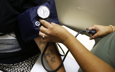 Janis Herrera gets her blood pressure measured on the first day of the new Pueblo del Rio Housing Projects Wellness Center, a free clinic that will serve 3,500 low income residents, in Los Angeles