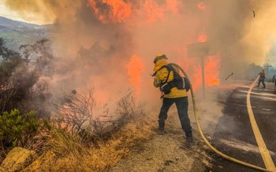 Firefighters work to extinguish a fire in Alpine, California