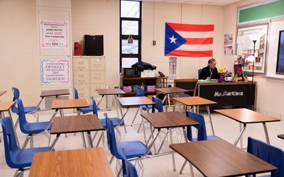 Ms. Martinez, a teacher at Iroquois High School, juggles between hers and her children's classes during a virtual learning day