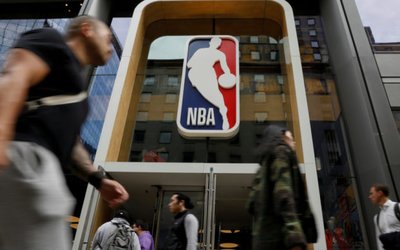 The NBA logo is displayed as people pass by the NBA Store in New York