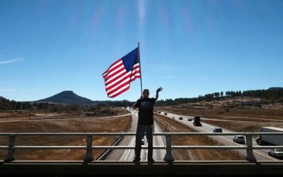 CASTLE ROCK, CO - OCTOBER 28: Curt Cook, 55, of Denver waves to