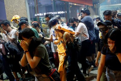 Anti-extradition bill protesters react after the police fired tear gas to disperse the demonstration at Sham Shui Po, in Hong Kong