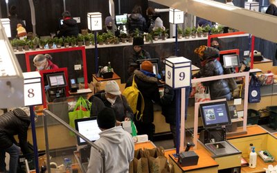 FILE PHOTO: People pay for their purchases at a supermarket in Manhattan, New York City