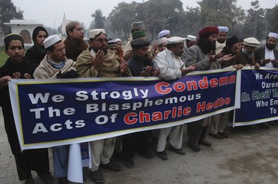 Men and students of Ghausia Madrassa, an Islamic school, offer funeral prayers in Peshawar