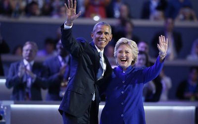 Democratic presidential nominee Hillary Clinton stands with President Barack Obama after his speech at the Democratic National Convention in Philadelphia, Pennsylvania