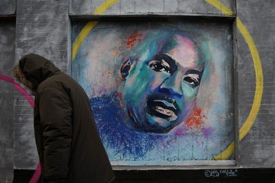 A person walks past a mural of Martin Luther King Jr. during the celebration of MLK Community Service Day in Washington