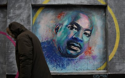 A person walks past a mural of Martin Luther King Jr. during the celebration of MLK Community Service Day in Washington