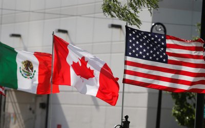 Flags of the U.S., Canada and Mexico fly next to each other in Detroit, Michigan