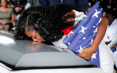 Myeshia Johnson, wife of U.S. Army Sergeant La David Johnson, who was among four special forces soldiers killed in Niger, kisses his coffin at a graveside service in Hollywood