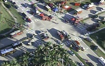 Police and rescue workers attend the scene near Marjory Stoneman Douglas High School following a shooting incident in Parkland
