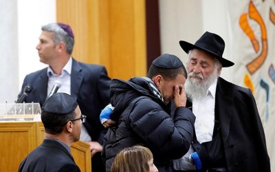 Rabbi Goldstein consoles a man at the funeral for Gilbert-Kaye in Poway