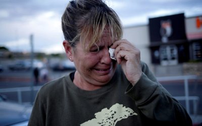 A woman reacts after a mass shooting at a Walmart in El Paso
