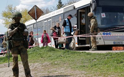 Civilians who left the area near Azovstal steel plant in Mariupol board a bus near a temporary accommodation centre in Bezimenne