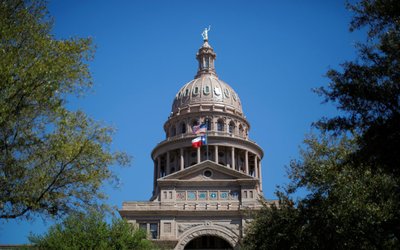 The U.S flag and the Texas State flag fly over the Texas State Capitol as the state senate debates the #SB6 bathroom bill in Austin