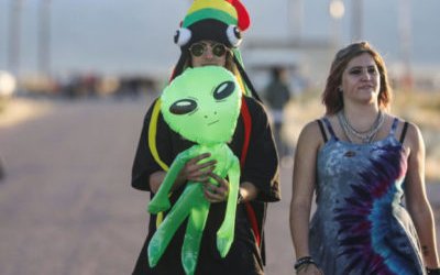 People walk near a gate to Area 51 as an influx of tourists responding to a call to 'storm' Area 51, a secretive U.S. military base believed by UFO enthusiasts to hold government secrets about extra-terrestrials, is expected in Rachel, Nevada