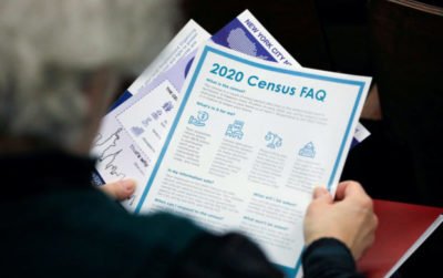 FILE PHOTO: A person holds census information at an event where U.S. Rep. Alexandria Ocasio-Cortez (D-NY) spoke at a Census Town Hall at the Louis Armstrong Middle School in Queens, New York City