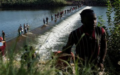 Migrants seeking asylum in the U.S. wait to be processed on the Mexico-U.S. border