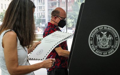 Voters submit ballots for New York's primary election at a polling station in Brooklyn, New York