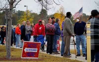 Voters line up to cast their ballots for the U.S. Senate runoff election in Muscogee County