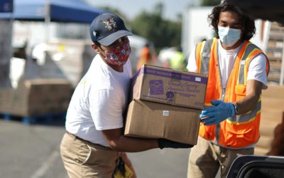 Los Angeles Food Bank volunteers hand out boxes of produce in Montebello