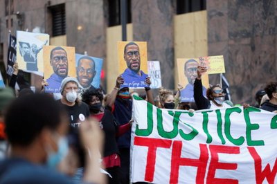 Protesters march for George Floyd on the day of opening statements for the trial of Chauvin in Minneapolis