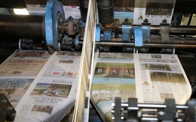 The first copies of the inaugural Los Angeles Register newspaper run off the presses in Santa Ana