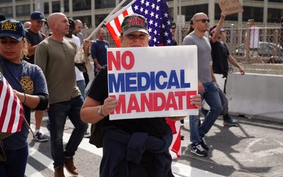 People march to protest against New York City mandated vaccines against the coronavirus disease (COVID-19) in New York