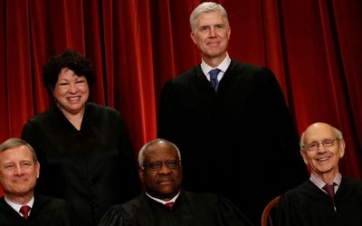 FILE PHOTO: Gorsuch smiles as he joins his fellow justices for a new U.S. Supreme Court family photo including him, their most recent addition, at the Supreme Court building in Washington