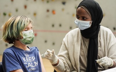 Children receive COVID-19 vaccines at a school-day clinic in Seattle