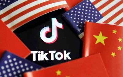 FILE PHOTO: Illustration picture of Tiktok with U.S. and Chinese flags