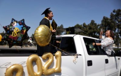 Student Angelo Gallardo, 24, takes part in a drive-through graduation at Rio Hondo community college, as the coronavirus (COVID-19) disease continues, in Whittier, near Los Angeles