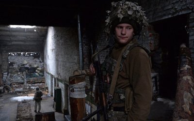 Ukrainian service members guard the area near the line of separation in the Donetsk Region