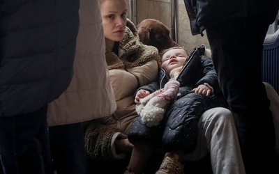 People wait to board an evacuation train at Kyiv central train station
