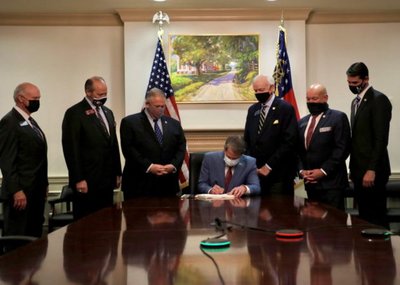 Handout photo of Georgia Governor Brian Kemp signing a restrictive voting bill