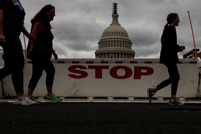Tourists walk past the U.S. Capitol in Washington